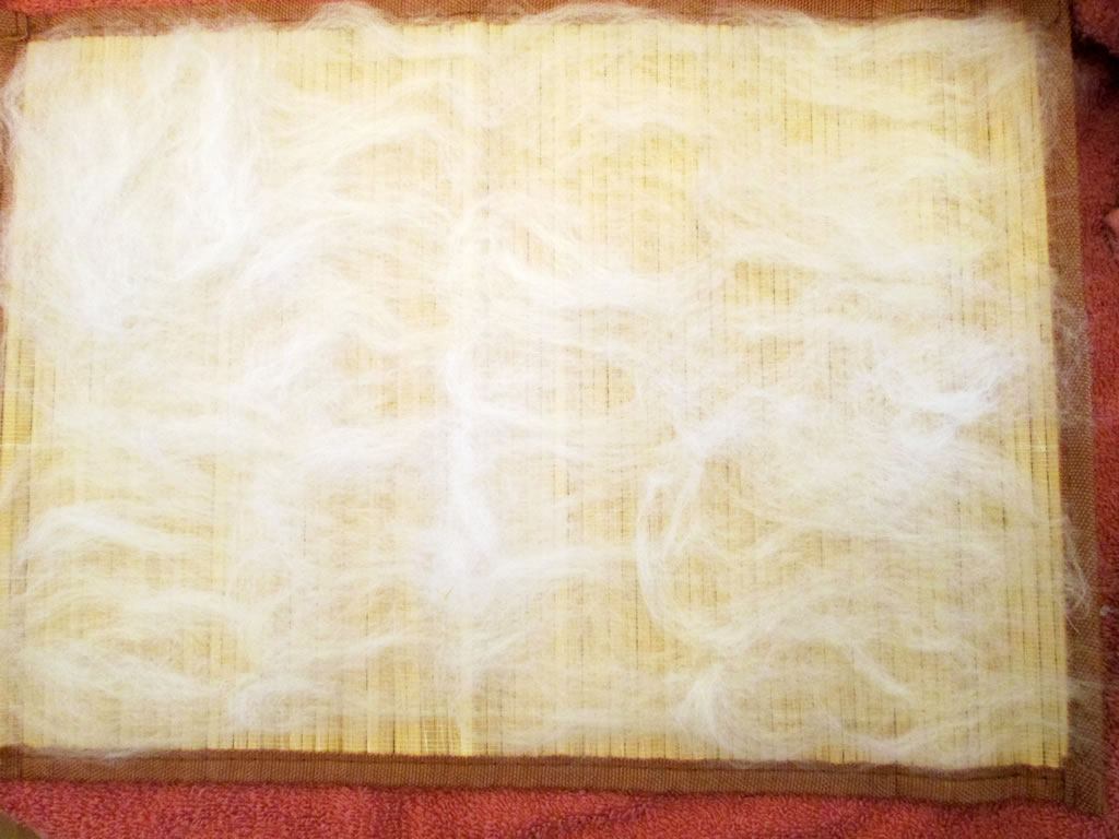 adding fibres to handmade felt