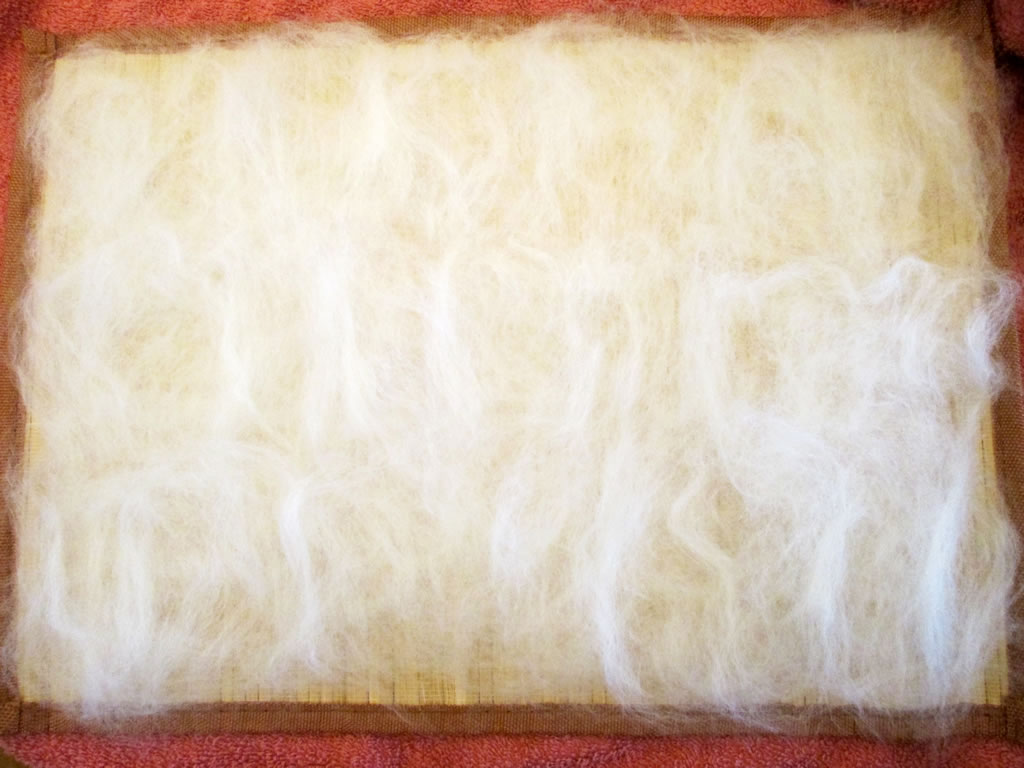 adding fibres to handmade felt